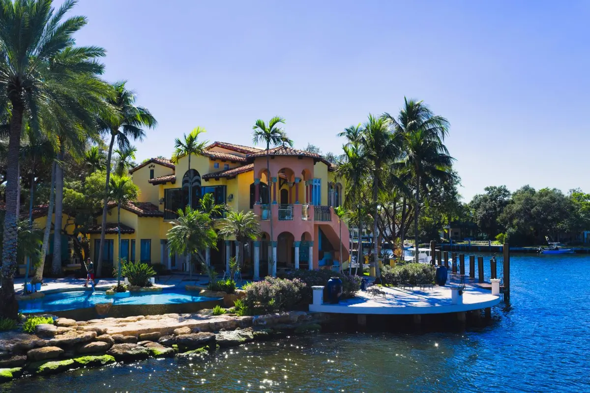 Waterfront Florida home with palm trees and a pool